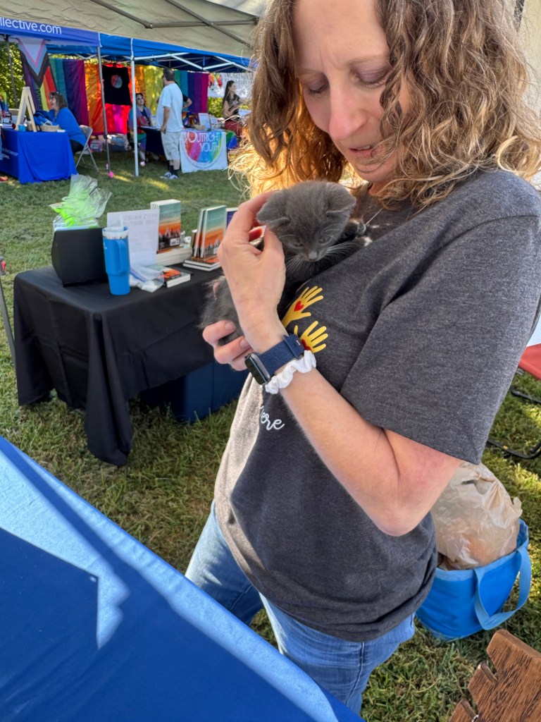 The author holding a tiny kitten